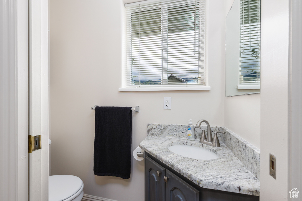 Half bath with vanity and toilet