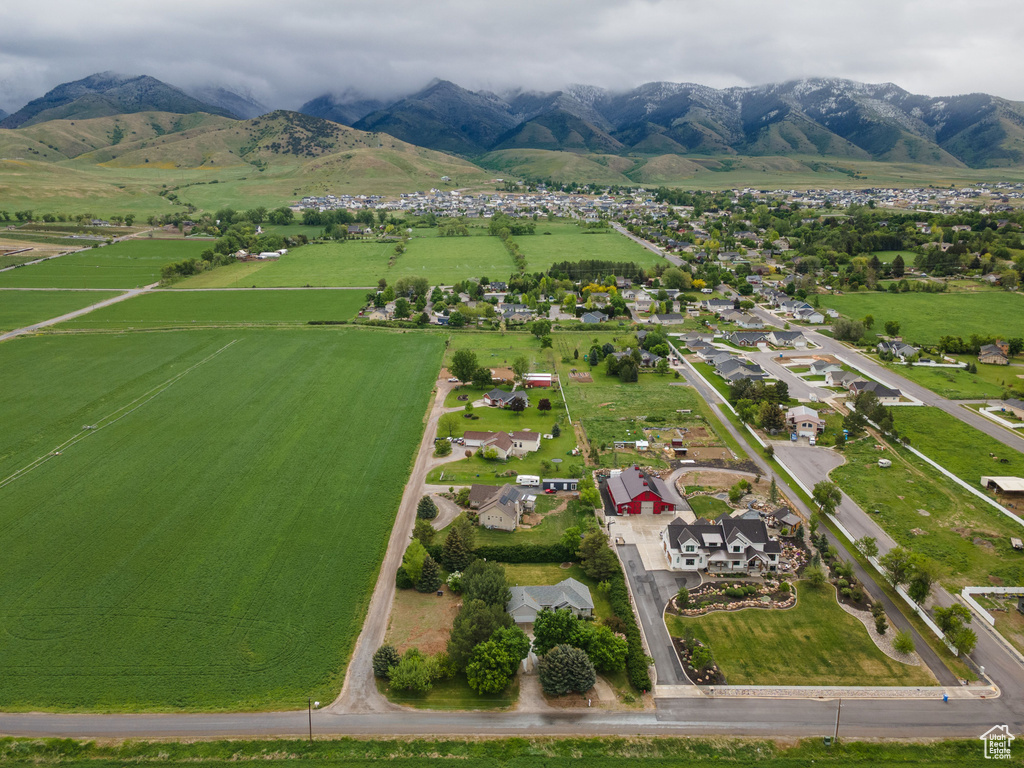 View of rural area with a mountain backdrop and nearby suburban area