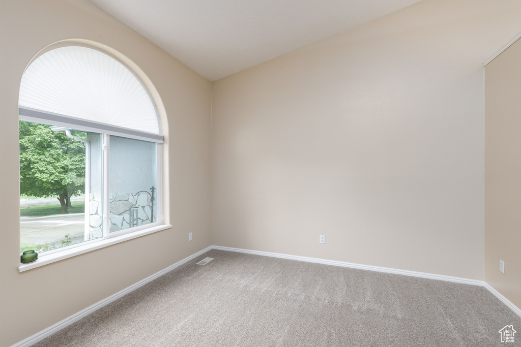Empty room with carpet floors and baseboards