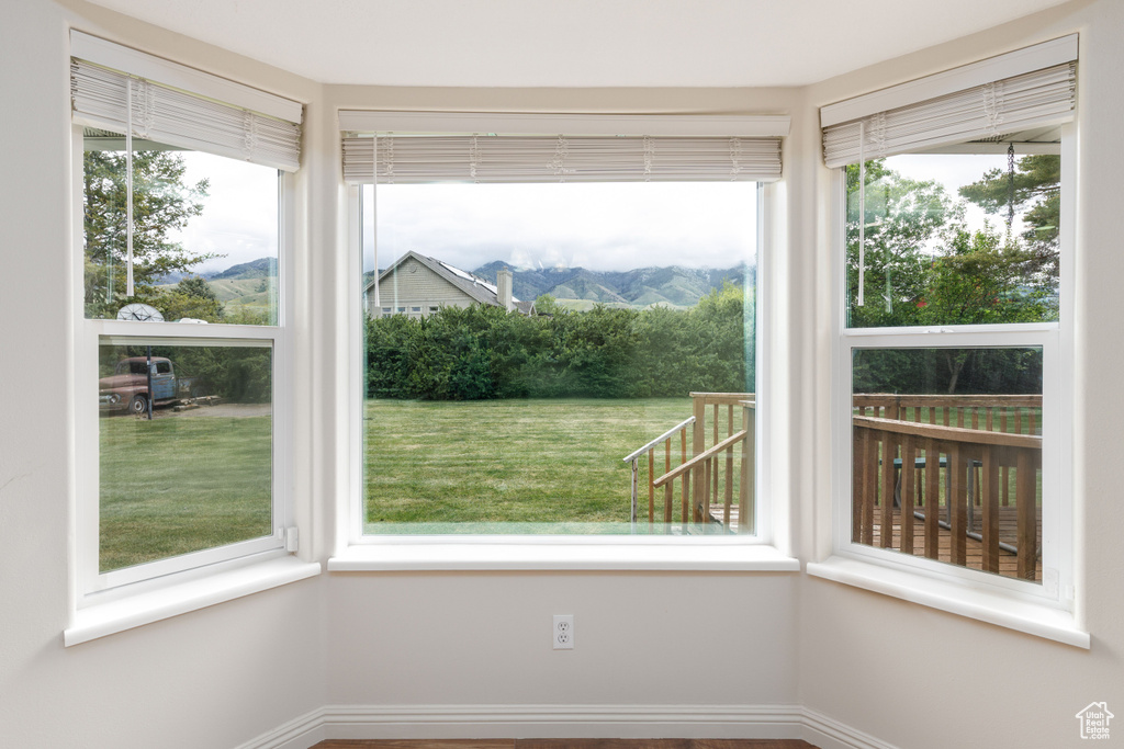 Unfurnished sunroom featuring healthy amount of natural light and a mountain view