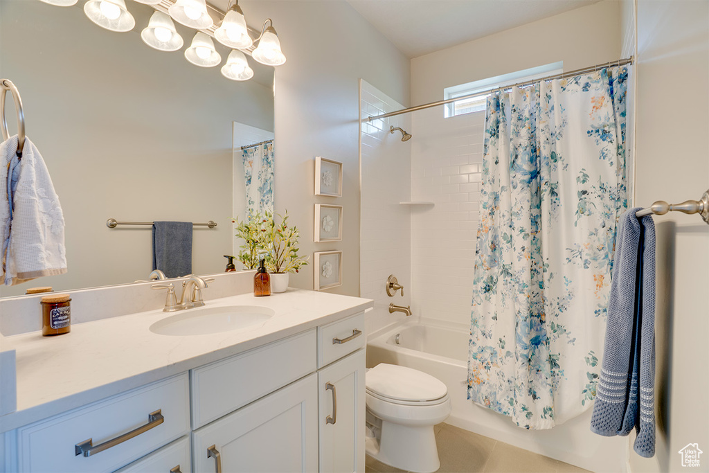 Bathroom featuring shower / tub combo with curtain, vanity, and toilet