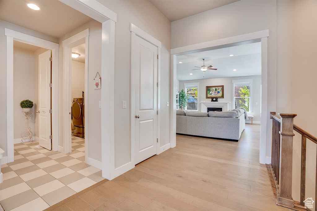 Corridor featuring recessed lighting, baseboards, light wood-style floors, and washer / clothes dryer
