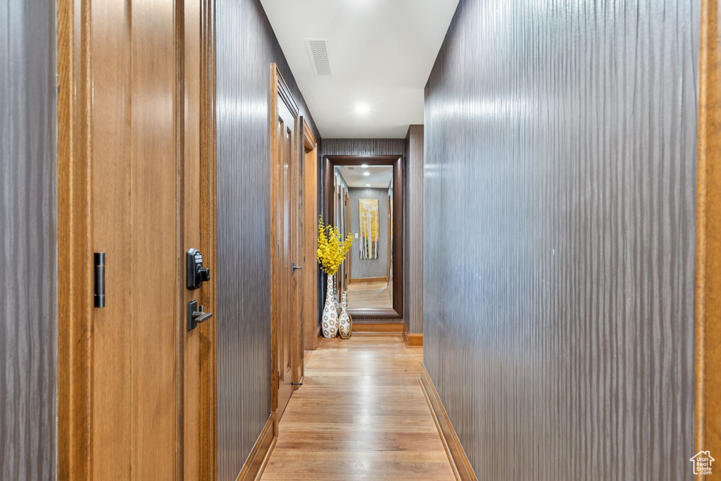 Corridor with wood finished floors and baseboards