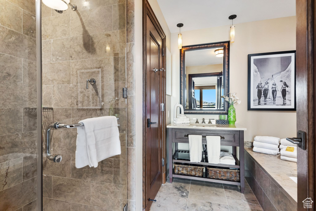 Full bathroom with a shower stall and vanity