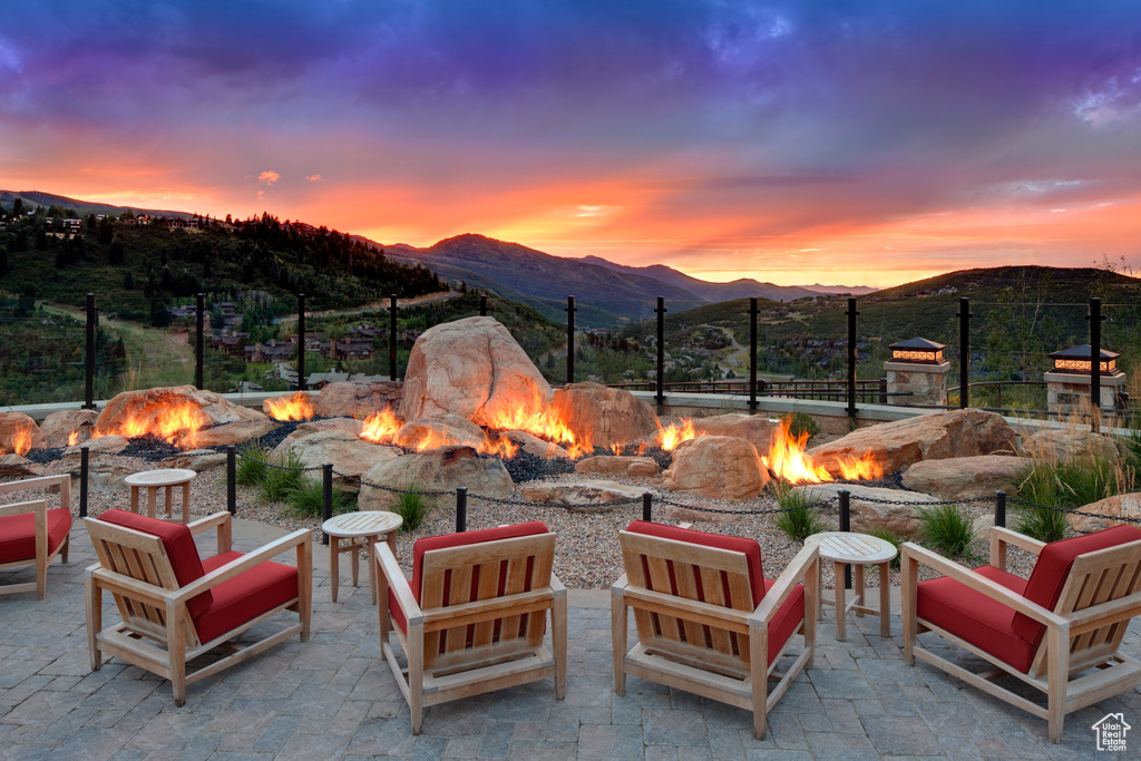 View of patio / terrace with an outdoor fire pit and a mountain view