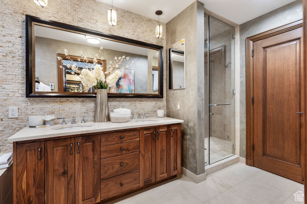 Full bathroom with a shower stall and double vanity