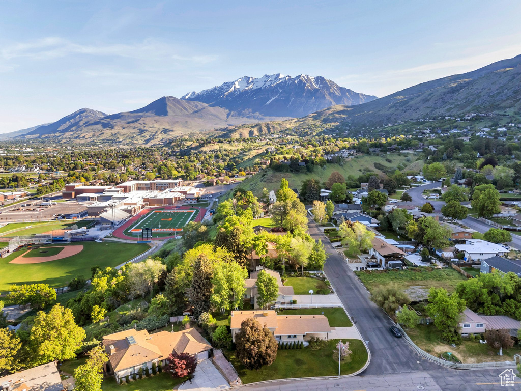 Aerial perspective of suburban area featuring a mountainous background