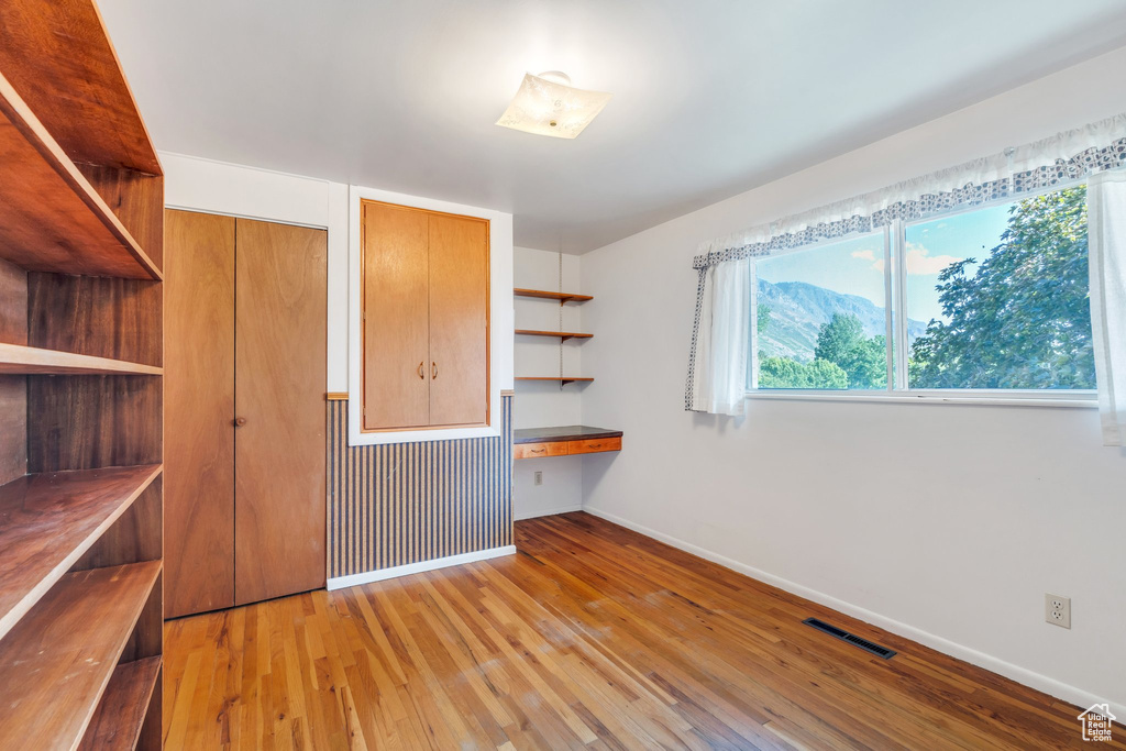 Unfurnished bedroom with baseboards and light wood-style floors