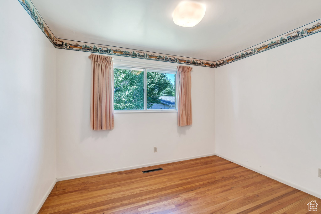 Empty room featuring light wood-type flooring and baseboards