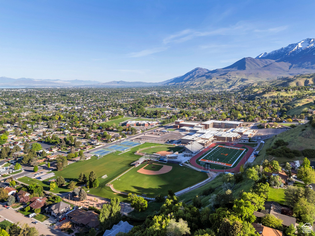 Aerial view of property's location with a mountain backdrop and nearby suburban area