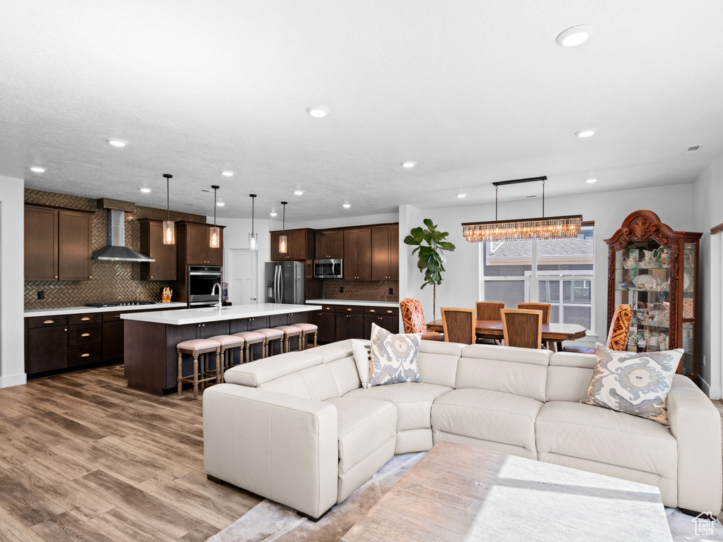 Living area featuring light wood finished floors and recessed lighting