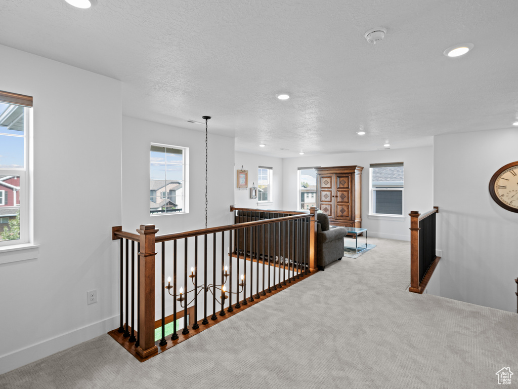 Hall featuring an upstairs landing, recessed lighting, carpet floors, healthy amount of natural light, and baseboards