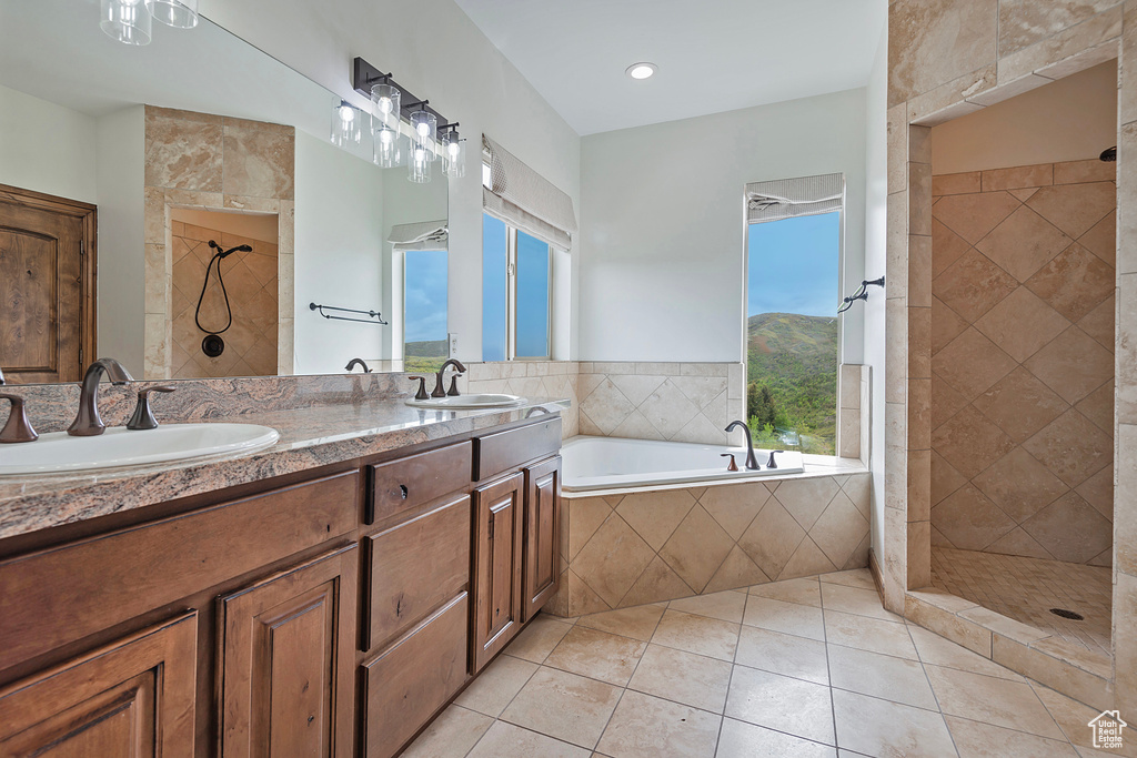 Full bath featuring tiled shower, tile patterned flooring, a garden tub, and double vanity