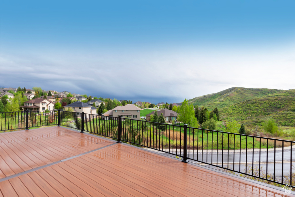 Wooden terrace with a residential view and a mountain view