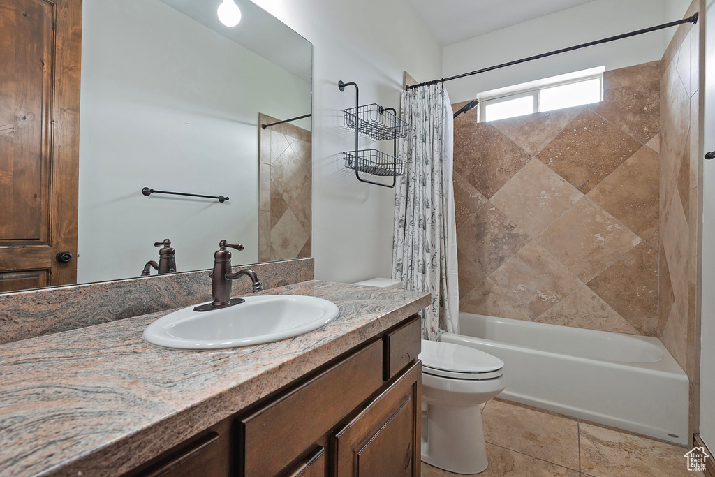 Full bath with toilet, shower / bathtub combination with curtain, and vanity
