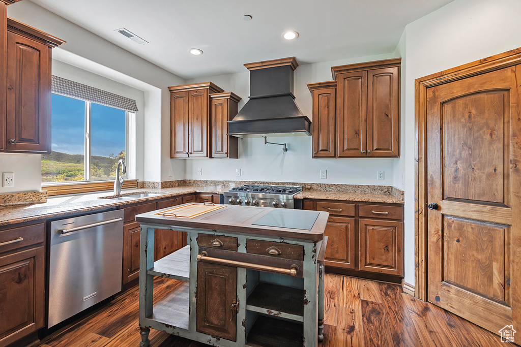 Kitchen featuring dishwasher, custom range hood, a sink, dark wood-type flooring, and recessed lighting