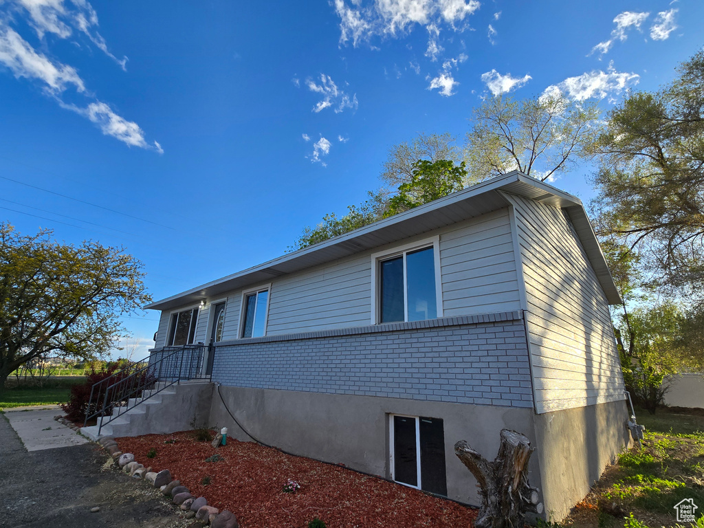 View of property exterior with brick siding