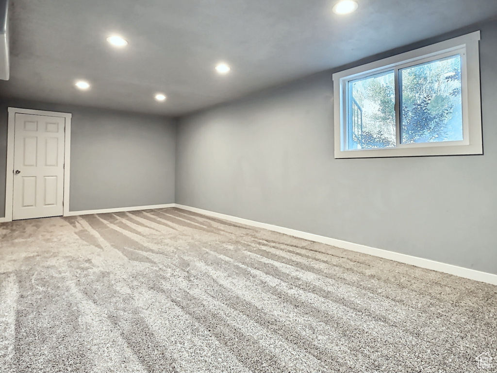 Empty room featuring recessed lighting, baseboards, and carpet flooring