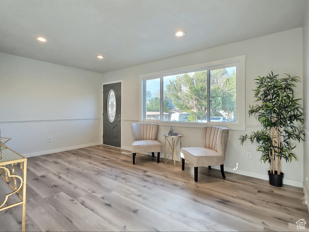 Living area with recessed lighting, wood finished floors, and baseboards