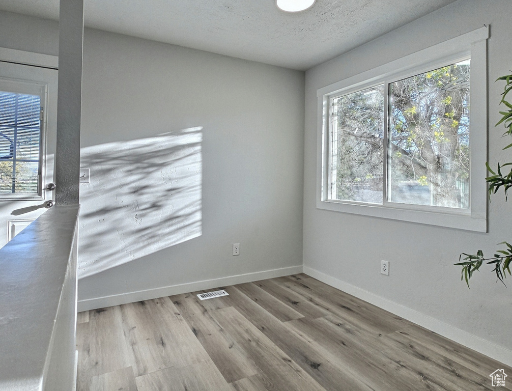 Unfurnished room featuring wood finished floors and baseboards
