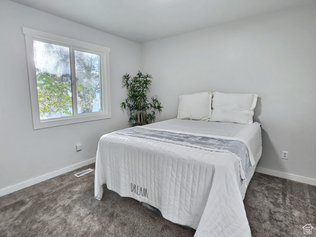 Bedroom with carpet flooring and baseboards