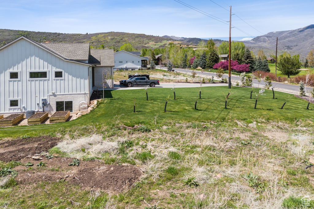 View of yard featuring a mountain view and fence