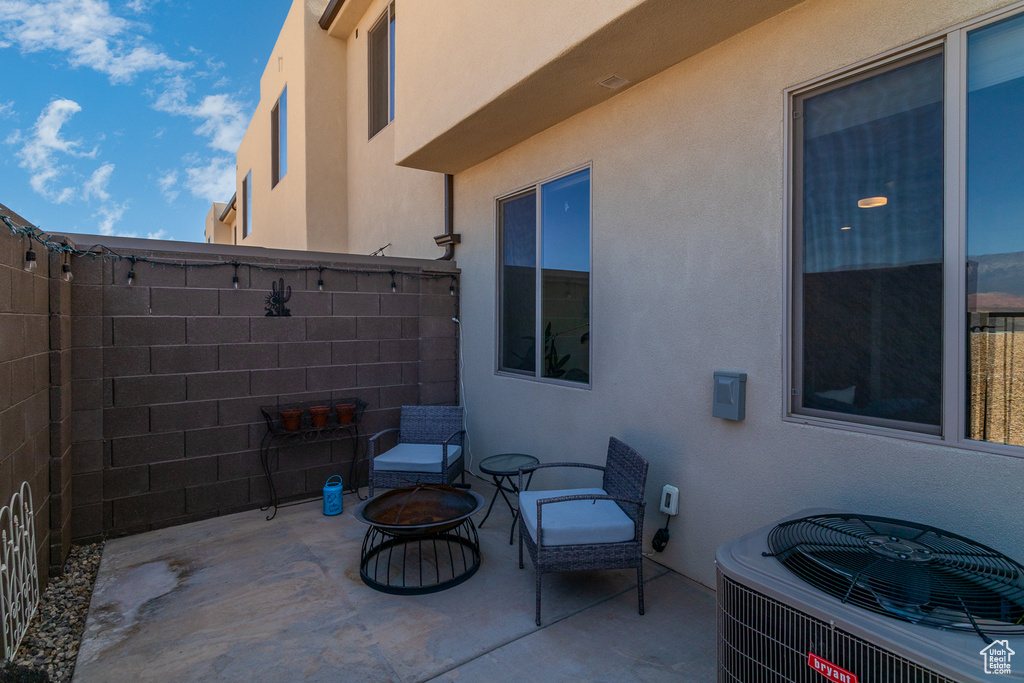 View of patio / terrace with central air condition unit and an outdoor fire pit