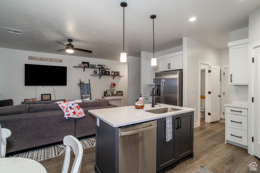 Kitchen featuring appliances with stainless steel finishes, open floor plan, dark wood finished floors, ceiling fan, and recessed lighting