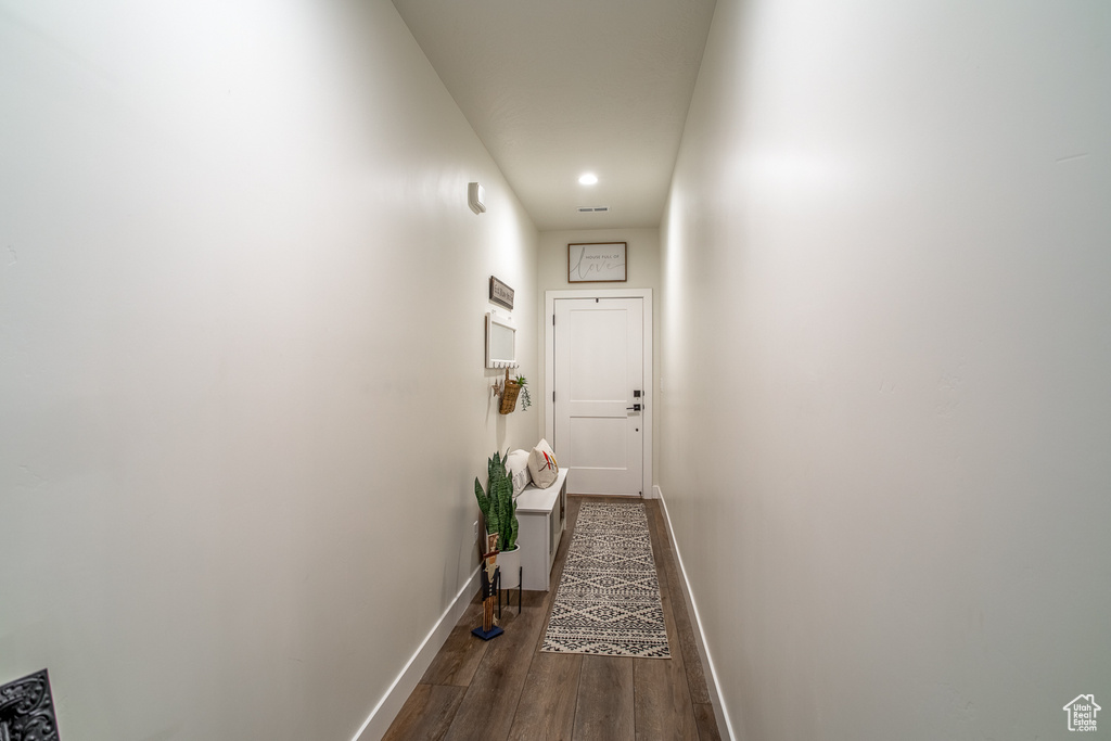 Corridor featuring wood finished floors, baseboards, and recessed lighting