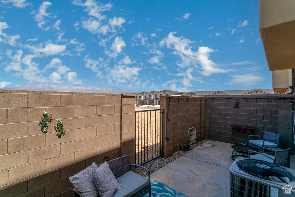 View of patio / terrace featuring central AC and fence