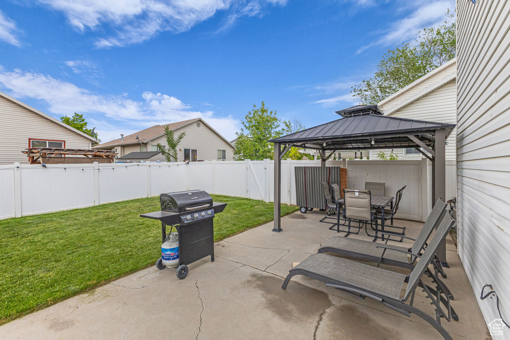 View of patio / terrace with a gazebo, a grill, and outdoor dining space