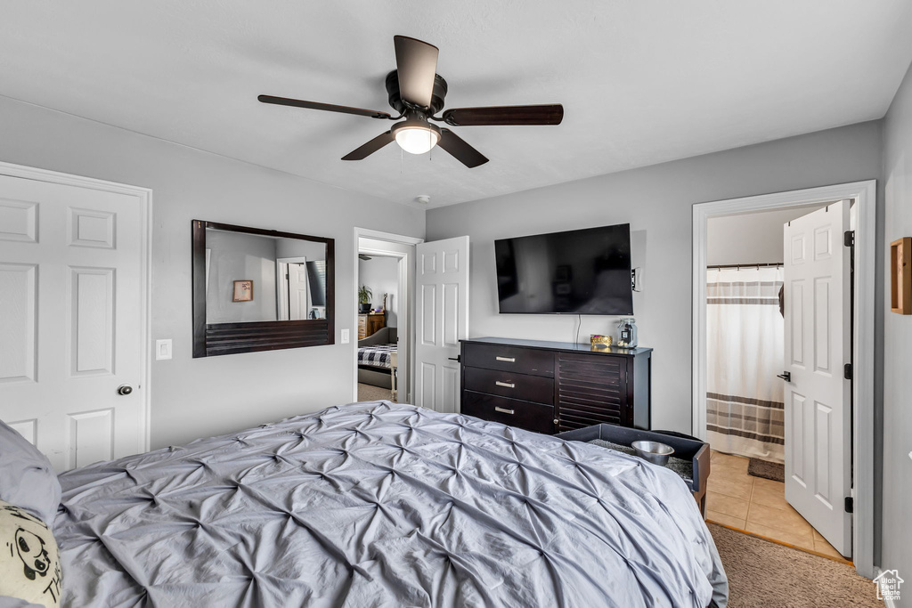 Bedroom with light tile patterned flooring and ceiling fan