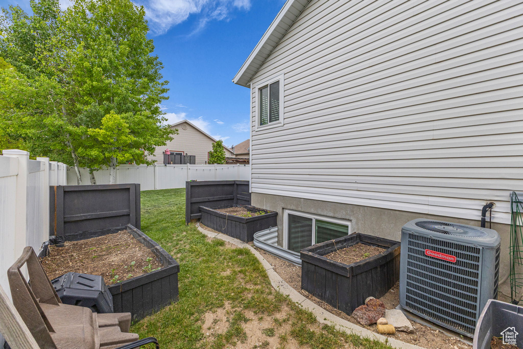 View of yard with a garden and cooling unit