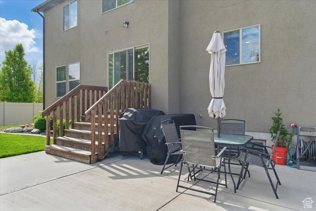 View of patio / terrace with area for grilling, fence, and outdoor dining space