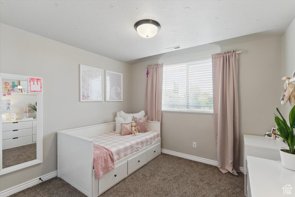 Carpeted bedroom featuring baseboards