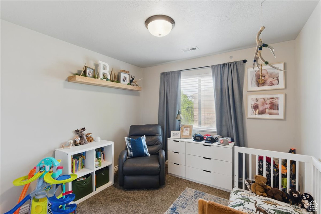 Carpeted bedroom with a crib