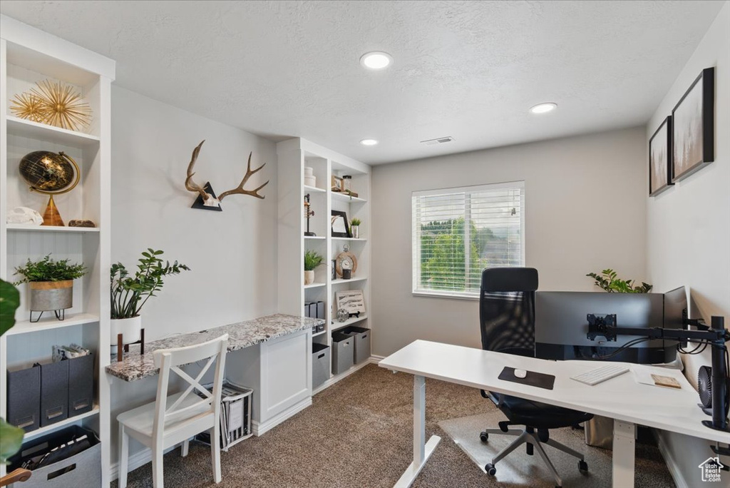 Carpeted home office featuring recessed lighting and a textured ceiling