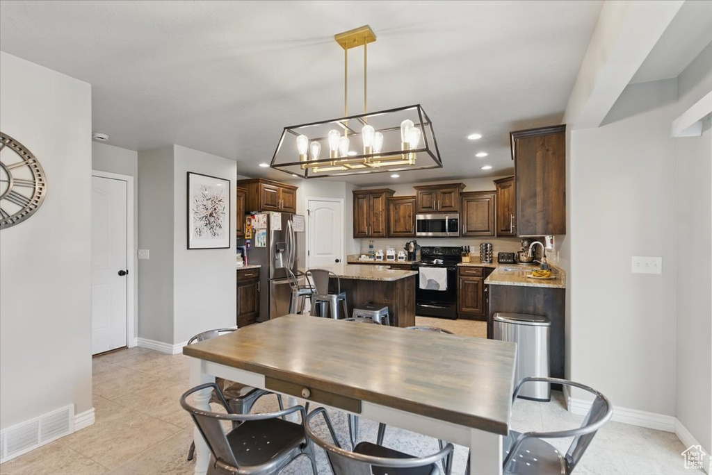 Dining space featuring baseboards, recessed lighting, a chandelier, and light tile patterned floors