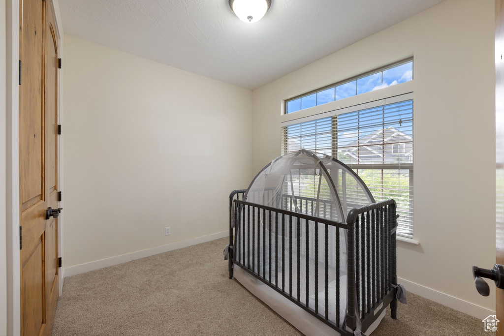 Bedroom featuring carpet flooring and baseboards