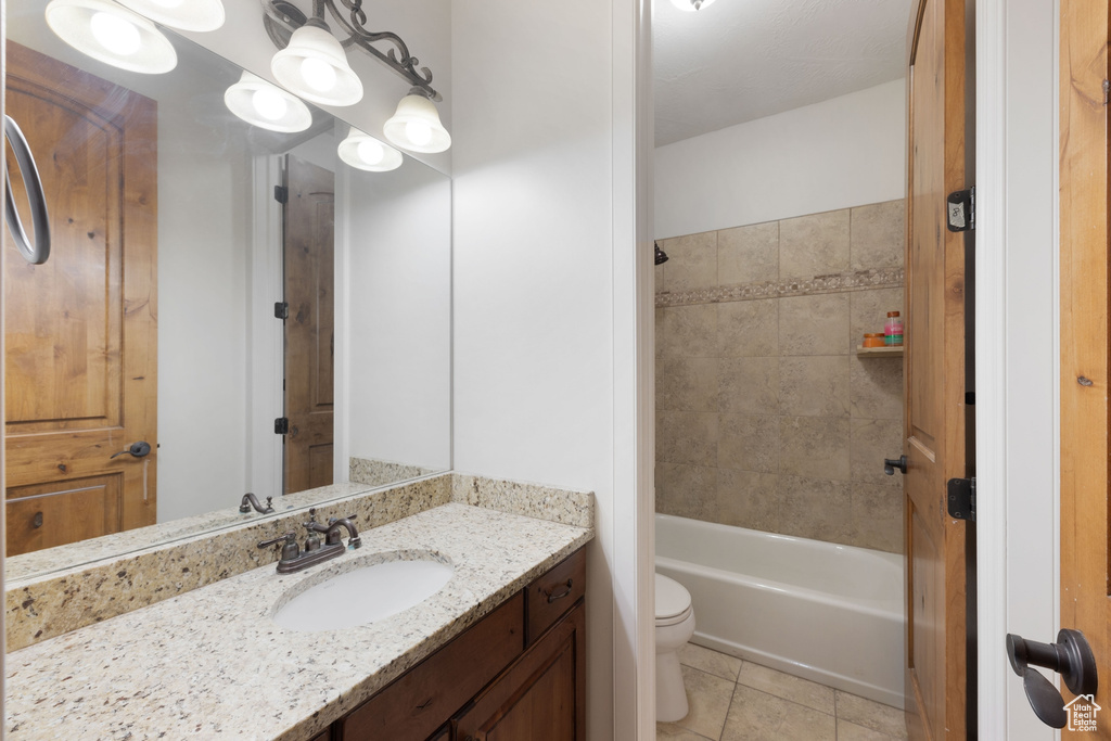 Full bathroom featuring toilet, tile patterned floors, vanity, and shower / bathtub combination