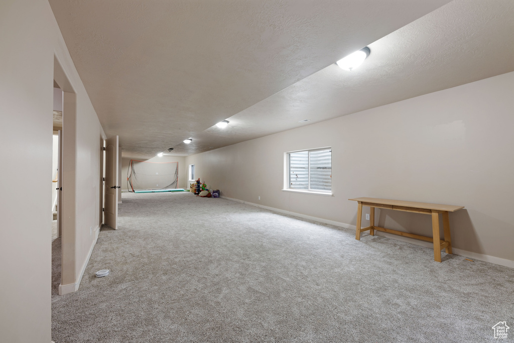 Below grade area with carpet flooring and baseboards
