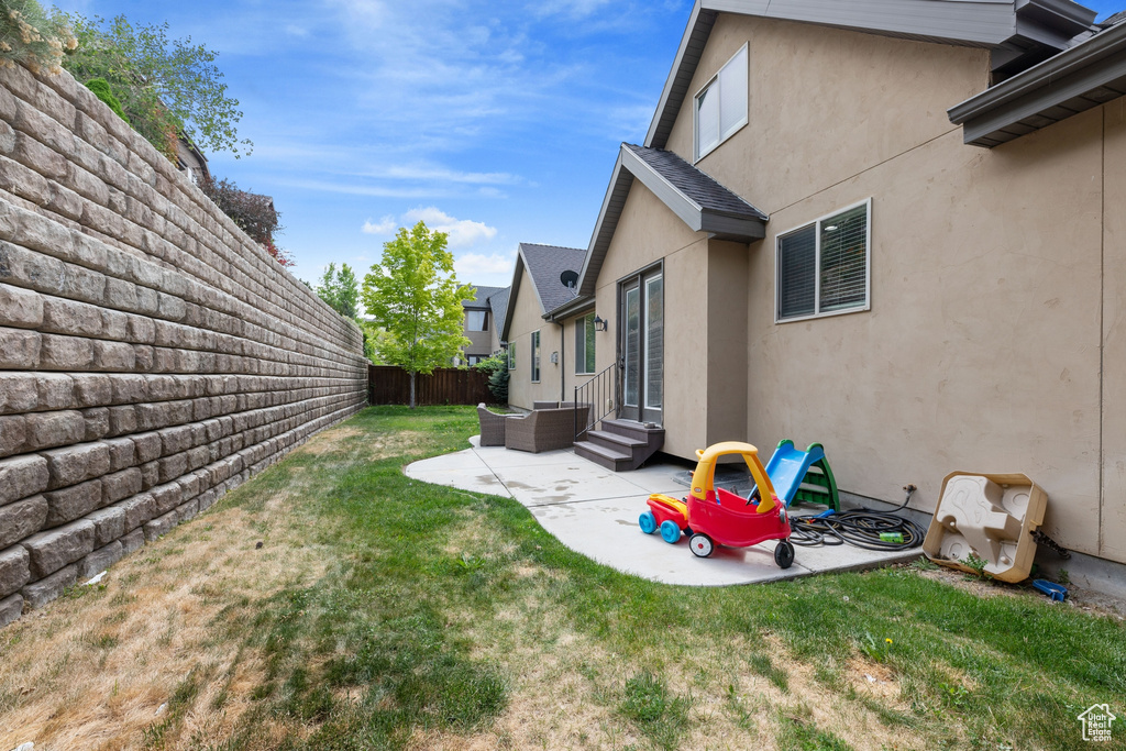View of yard with a patio area and entry steps