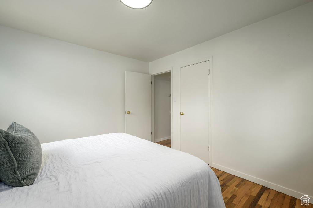 Bedroom with baseboards and wood finished floors