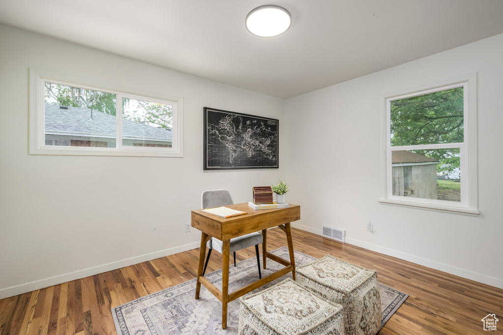 Office area with baseboards and wood finished floors