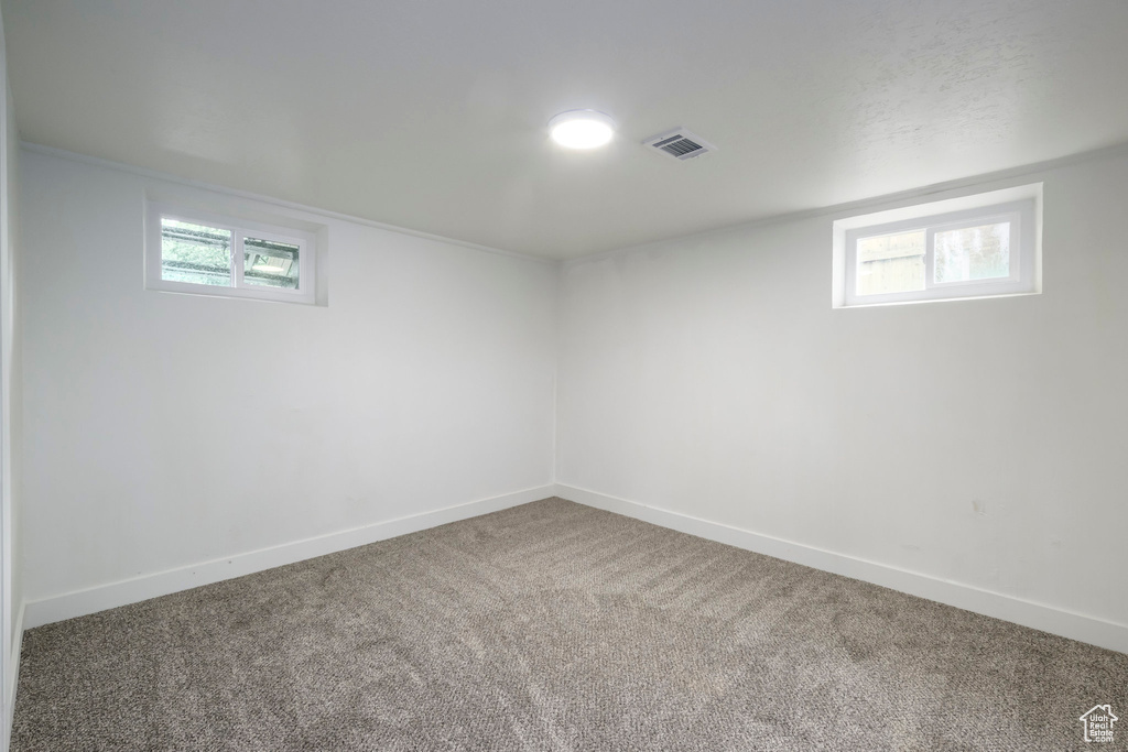 Basement with carpet floors and baseboards