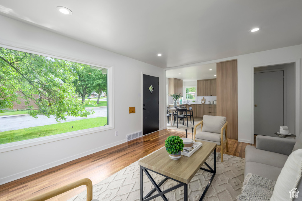 Living area featuring light wood-type flooring, recessed lighting, and baseboards