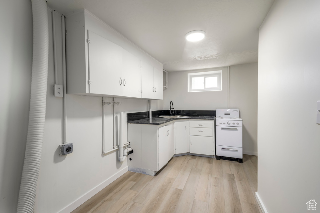 Washroom with light wood-style floors and baseboards