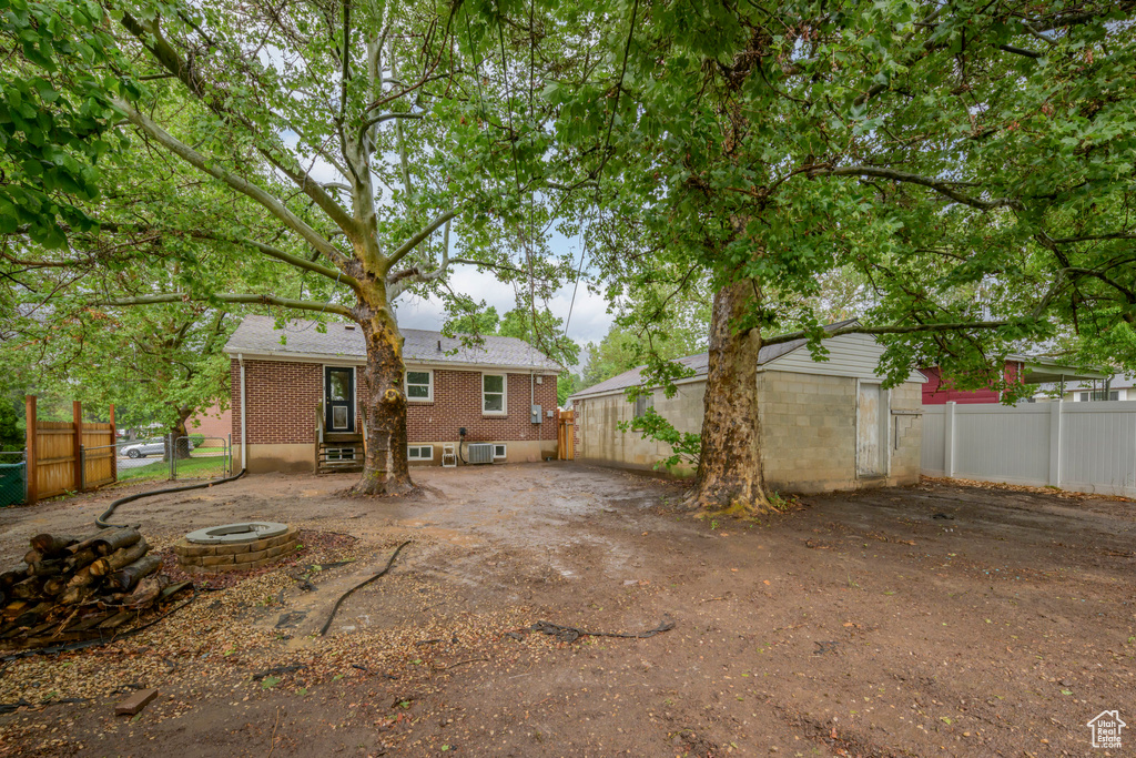 Rear view of house featuring fence and brick siding
