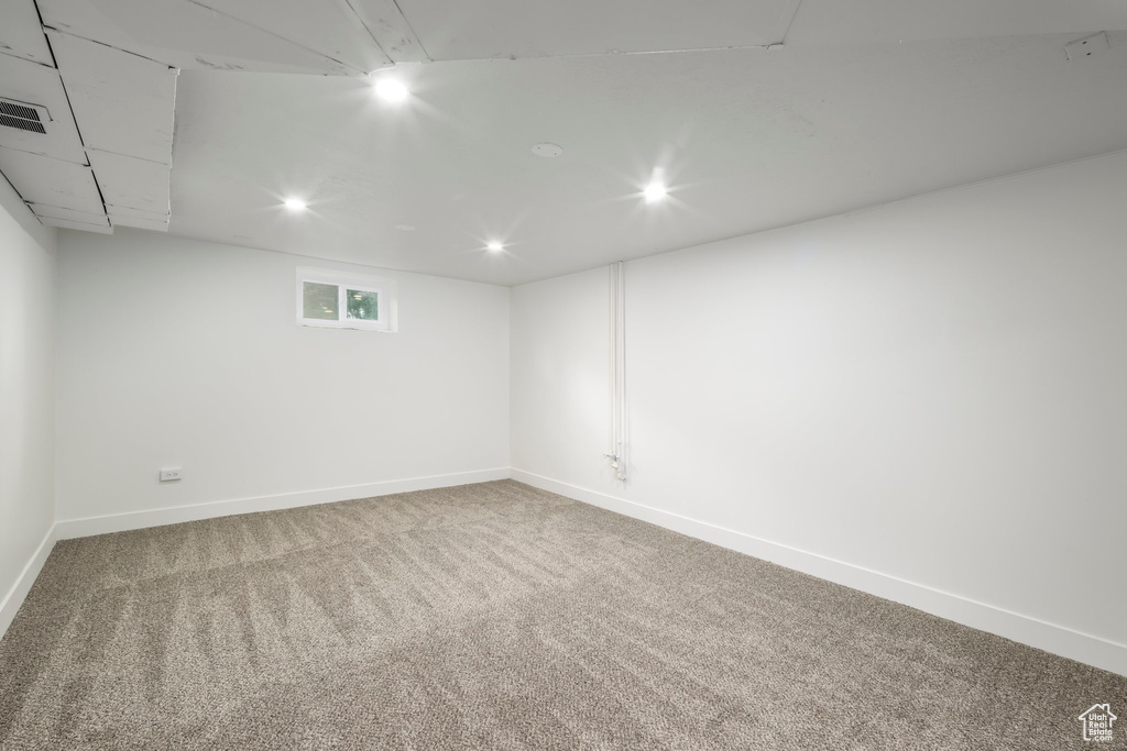 Below grade area with carpet floors, baseboards, and recessed lighting