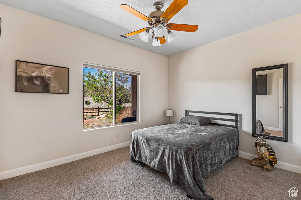 Bedroom featuring carpet, baseboards, and ceiling fan
